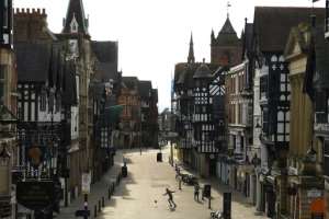 A man plays with a football in a near-deserted Chester city centre during the lockdown in England in April. By Oli SCARFF (AFP/File)