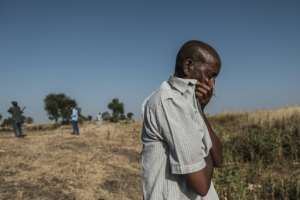 A man reacts near a body-filled ditch outside Mai-Kadra, where 600 civilians are believed to have been massacred. By EDUARDO SOTERAS (AFP/File)