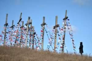 A man stands in front of giant crosses in the town of Achmiany, some 130 km northwest of Minsk, during Palm Sunday celebrations. By Sergei GAPON (AFP)