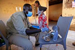 A medic disinfects tools at a medical facility in Um Raquba, a camp that has been set up for Ethiopian refugees in eastern Sudan. By ASHRAF SHAZLY (AFP)