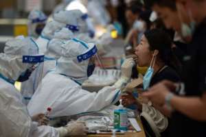 A medical worker performs a Covid test in Jiangsu province, China. By STR (AFP)