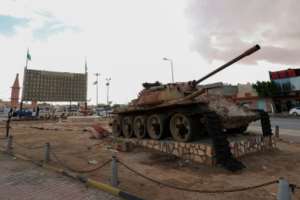 A memorial commemorating pro-Kadhafi Libyans killed in post-2011 confrontations behind a damaged tank, in the city of Bani Walid, about 180 kilometers southeast of the capital. By Mahmud TURKIA (AFP/File)