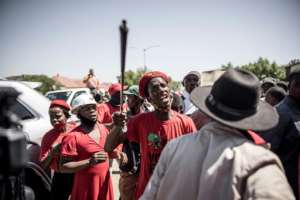 A member of the Economic Freedom Fighters confronts farmers in Senekal. By MARCO LONGARI (AFP)