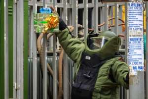 A member of the Uganda police bomb squad prepares to detonate a suspicious package near the Central Police Station in Kampala. By Badru KATUMBA (AFP)