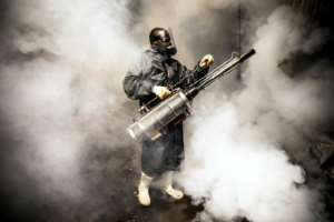 A member of a privately-funded NGO fumigates and disinfects the streets and the stalls at Parklands City Park Market in Nairobi, Kenya. By LUIS TATO (AFP)