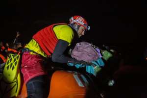 A member of Proactiva Open Arms organisation holds a new born baby rescued with her mother.  By Olmo CALVO (AFP/File)