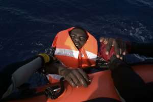 A migrant is rescued by members of the Proactiva Open Arms NGO in the Mediterranean Sea off the coast of Libya on October 4, 2016