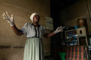 A moment for prayer: Gwena belongs to an Apostolic religious sect where she says she got her calling to take up midwifery. She says she has delivered as many as 250 children. By Jekesai NJIKIZANA (AFP)