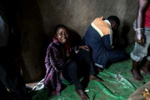 A mother mourns the death of two of her sons, allegedly killed the night before by ADF militia forces, in Beni. By JOHN WESSELS (AFP)