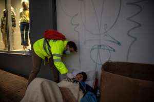 A nurse in Athens takes a swab from a homeless man for an antigenic test as Greece faces a new wave of Covid-19 infections. By ANGELOS TZORTZINIS (AFP)