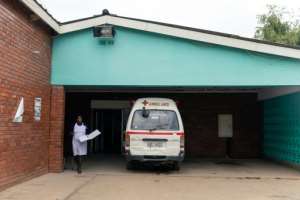 A nurse walks past one of the few working ambulances in Chitungwiza, a dormitory town of the Zimbabwean capital Harare. By Jekesai NJIKIZANA (AFP)