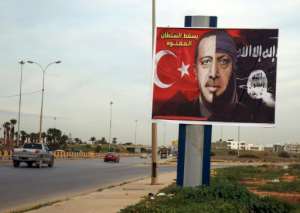 A billboard defaming Turkish President Recep Tayyip Erdogan as a member of the Islamic State group in the port city of Benghazi in eastern Libya.  By Abdullah DOMA (AFP / File)