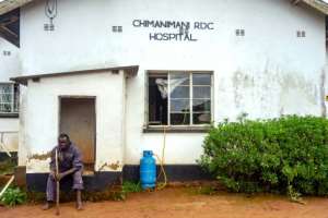 A cyclone survivor sits outside Chimanimani Rural District Hospital. By Zinyange AUNTONY (AFP)