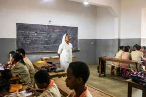 A Catholic nun teaches at a class at St. John's high school. Many Muslim parents in Madagascar speak highly of the quality of education in Catholic schools and say they are unfazed by the Christian component of the curriculum. By Fita Fanomezantsoa (AFP)