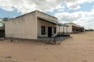 A child stands outside a general store which serves beneficiaries of a World Food Programme sponsored cash transfer assistance programme. By Jekesai NJIKIZANA (AFP/File)