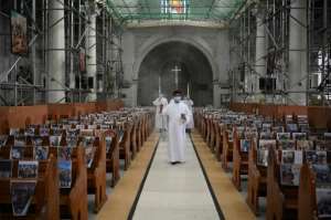 A church in the Philippines taped photos of parishioners to pews for their Sunday Easter service. By Ted ALJIBE (AFP)