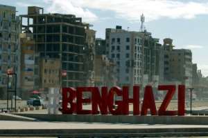 A city name sign is pictured in front of war-ravaged buildings in Libya's eastern city of Benghazi. By Abdullah DOMA (AFP/File)