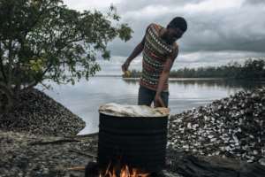 A clam fisher boils up his catch. By ALEXIS HUGUET (AFP)