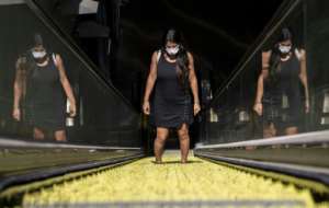 A commuter wears a face mask as she leaves a subway station in Santiago, Chile.  By MARTIN BERNETTI (AFP)