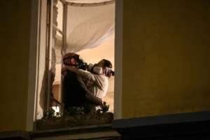A couple in masks embrace at their window during the daily 8 o'clock applause in support of medical workers in the French Riviera city of Nice. By VALERY HACHE (AFP)