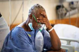 A Covid patient breathes oxygen in a special ward at Khayelitsha hospital near Cape Town.  By RODGER BOSCH (AFP)