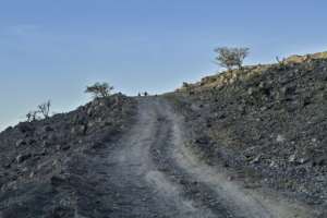 A dirt road crosses the rugged terrain near the remote site of Abourma which receives few tourists.  By TONY KARUMBA (AFP)