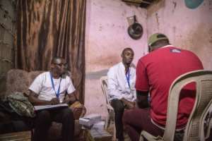 A doctor gives condoms and lubricants to a member of the gay community in a room at the video club. By STR (AFP)