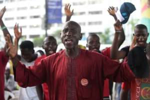 A father of one of the missing schoolgirls prays for his daughter's release at a vigil in Lagos ahead of the four-year anniversary of her abduction
