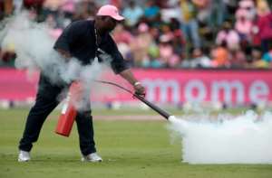 A field marshall fires an extinguisher onto a swarm of bees as the cricket match is suspended between South Africa and Sri Lanka at Wanderers cricket ground on February 4, 2017 in Johannesburg, South Africa
