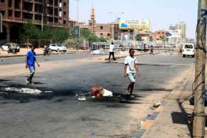 A fire burns at a street barricaded by anti-coup protesters in the Sudanese capital Khartoum on October 27, 2021. By - (AFP)