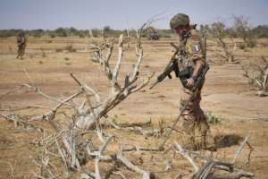 A French soldier on an exercise in Burkina Faso uses a bomb detector as he searches for a roadside device, one of the deadliest tactics used by jihadists. By MICHELE CATTANI (AFP)