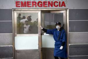 A guard stands at the entrance of the emergency room of a hospital in Santo Domingo, Dominican Republic. By Erika SANTELICES (afp/AFP)