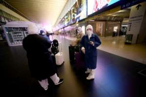 A group of asian travellers arrive in Termini central station in Rome, during Italy's lockdown. By Filippo MONTEFORTE (AFP)