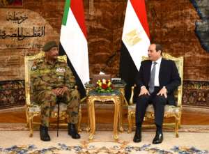 A handout picture released by the Egyptian Presidency on May 25, 2019 shows Egyptian President Abdel Fattah al-Sisi (R) meeting with Lieutenant General Abdel Fattah al-Burhan, chief of Sudan's ruling military council, in the capital Cairo. By STRINGER (EGYPTIAN PRESIDENCY/AFP/File)