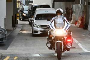 A hearse transporting Mugabe's body left a Singapore funeral parlour accompanied by a police escort. By Roslan RAHMAN (AFP)