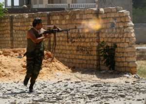 A Libyan fighter loyal to the Government of National Accord fires towards forces loyal to strongman Khalifa Haftar in the outskirts of Tripoli, on September 7, 2019. By Mahmud TURKIA (AFP/File)