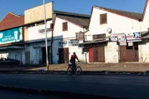 A lone cyclist makes his way in the usually bustling part of downtown Harare. By Jekesai NJIKIZANA (AFP)