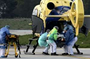 A patient is loaded into a helicopter at Paris Orly Airport, which has been transformed into an emergency evacuation air base for coronavirus sufferers. By Philippe LOPEZ (AFP)