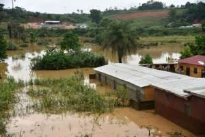 A picture shows flooded houses near the site of a landslide that killed at least 13 people in Anyama, near Abidjan.. By SIA KAMBOU (AFP)