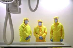 A picture taken by a doctor at a Cairo hospital shows radiology technicians posing for a picture in a lab in the isolation ward for COVID-19 patients. By Yahya DIWER (AFP/File)