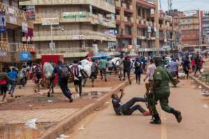 A police officer chases street vendors in Kampala, Uganda, after the public were directed to stay home for 32 days. By Badru KATUMBA (AFP)