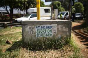 A poster advertising an illegal abortion in Johannesburg, as access to legal abortions have become more difficult. By LUCA SOLA (AFP)