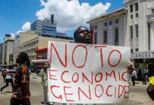 A protester holds a sign during a demonstration by opposition parties against the introduction of bond notes as a currency in Harare on November 30 2016