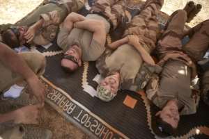 A quick lie-down: Soldiers grab a few moments' respite. By MICHELE CATTANI (AFP)
