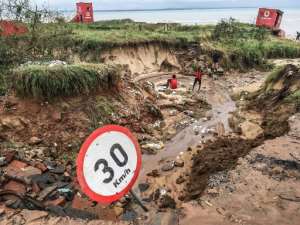 A road in Pemba destroyed by flooding in the provincial capital of Pemba. By STRINGER (AFP)
