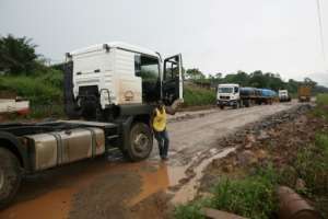 A road running parallel to the tracks is riddled with potholes. By STEVE JORDAN (AFP/File)