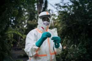 A staff member of the Congolese Ministry of Health prepares the sampling equipment to perform a COVID-19 test at a private residence in Goma, northeastern Democratic Republic of Congo. By ALEXIS HUGUET (AFP)