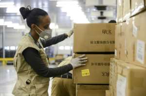A staff member of the World Food Programme (WFP) checks boxes of personal protective equipment at Ethiopian Airlines' cargo facility Addis Ababa's international airport earlier this month. By Samuel HABTAB (AFP/File)