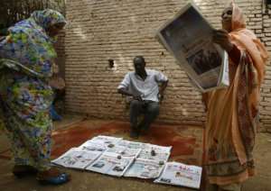 A Sudanese newspaper vendor sits in a street in Al-Jarif city outside the capital Khartoum, on May 25, 2015