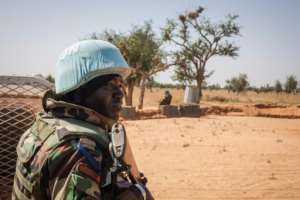 A Senegalese peacekeeper stands next to a United Nations armoured vehicle in Ogossagou. By AMAURY HAUCHARD (AFP)